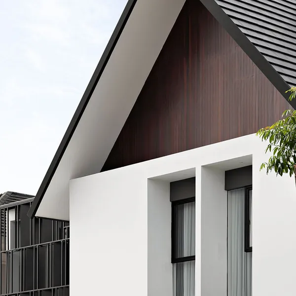 White gabled facade with dark timber cladding