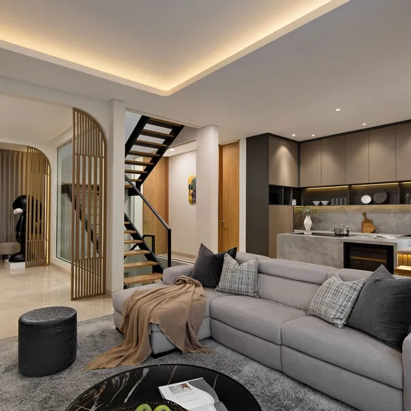 Open living room and kitchen with timber screens and warm cove lighting